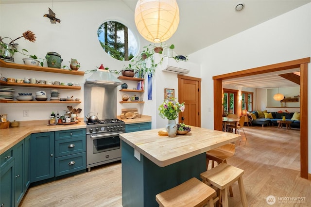 1692 Galbraith Ln, Bellingham, WA 98229 - kitchen with open shelves, butcher block counters, high end range, light wood-style floors, and ventilation hood