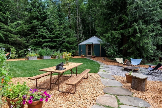 1692 Galbraith Ln, Bellingham, WA 98229 - view of green lawn featuring an outdoor structure and an outdoor fire pit
