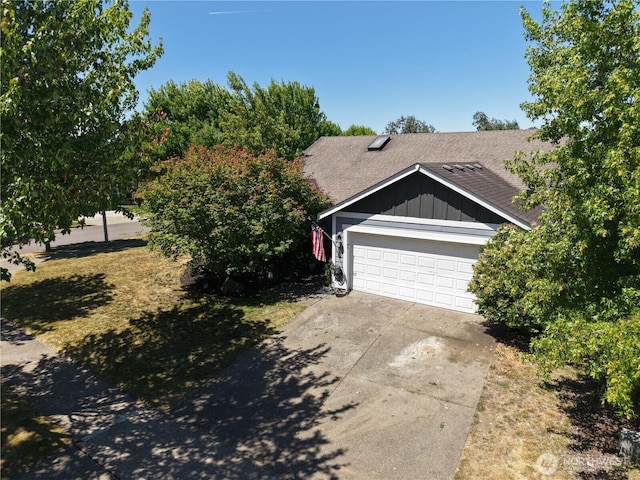 230 Goldmyer Dr, Chehalis, WA 98532 - view of front of property with concrete driveway, a garage, board and batten siding, and a shingled roof