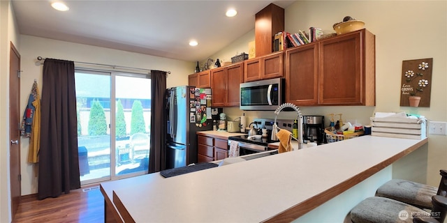 230 Goldmyer Dr, Chehalis, WA 98532 - kitchen featuring stainless steel appliances, brown cabinetry, light countertops, light wood-type flooring, and a peninsula