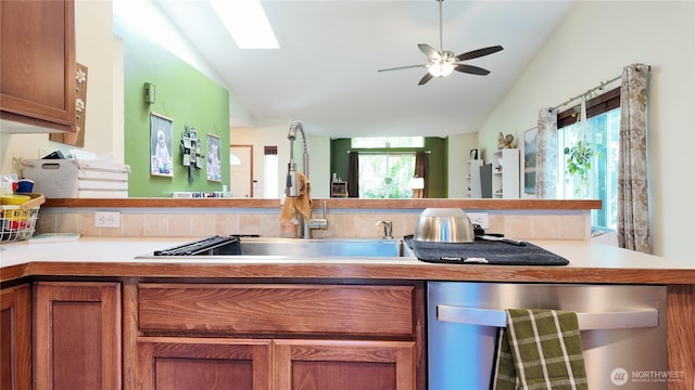 230 Goldmyer Dr, Chehalis, WA 98532 - kitchen with dishwasher, vaulted ceiling, brown cabinetry, light countertops, and a ceiling fan