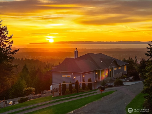 52 Carriage Dr, Sequim, WA 98382 - view of front of home featuring an attached garage, a chimney, and driveway