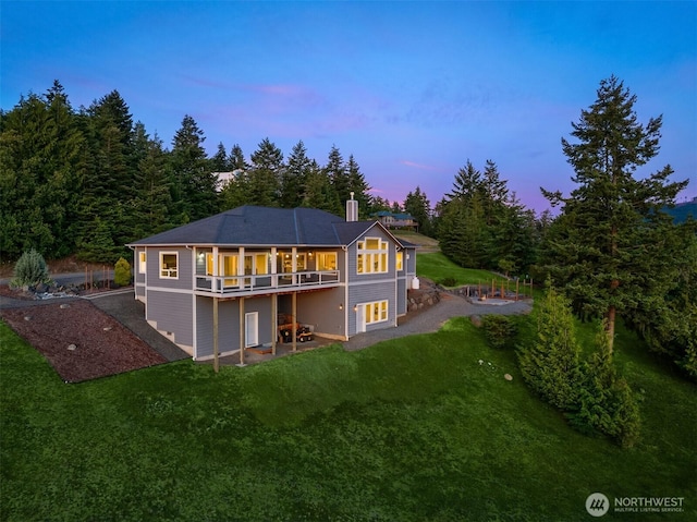 52 Carriage Dr, Sequim, WA 98382 - back of property with a lawn, a patio, and a wooden deck