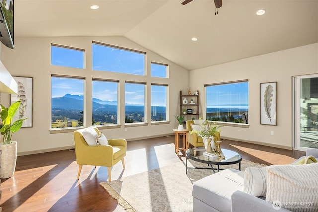 52 Carriage Dr, Sequim, WA 98382 - living room featuring a mountain view, wood finished floors, vaulted ceiling, plenty of natural light, and ceiling fan