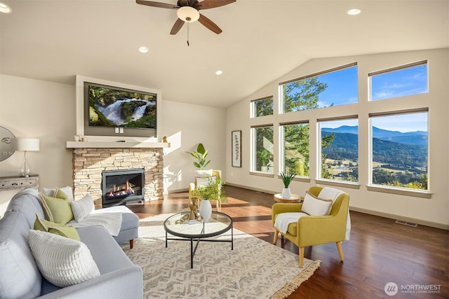 52 Carriage Dr, Sequim, WA 98382 - living room with a mountain view, a ceiling fan, wood finished floors, vaulted ceiling, and a fireplace