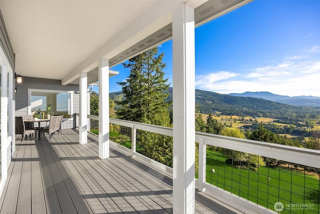 52 Carriage Dr, Sequim, WA 98382 - wooden deck featuring a mountain view and outdoor dining space