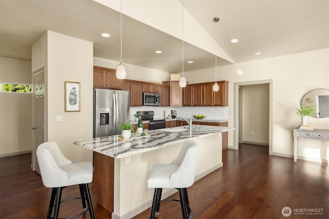 52 Carriage Dr, Sequim, WA 98382 - kitchen featuring stainless steel appliances, dark wood finished floors, light stone counters, an island with sink, and recessed lighting