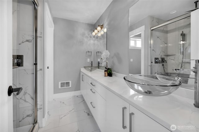 1315 Astor St, Bellingham, WA 98225 - bathroom featuring double vanity, a marble finish shower, and marble look tiles