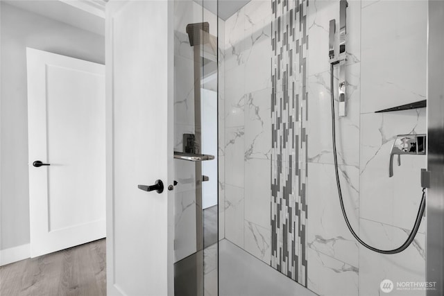 1315 Astor St, Bellingham, WA 98225 - bathroom featuring a marble finish shower and wood finished floors