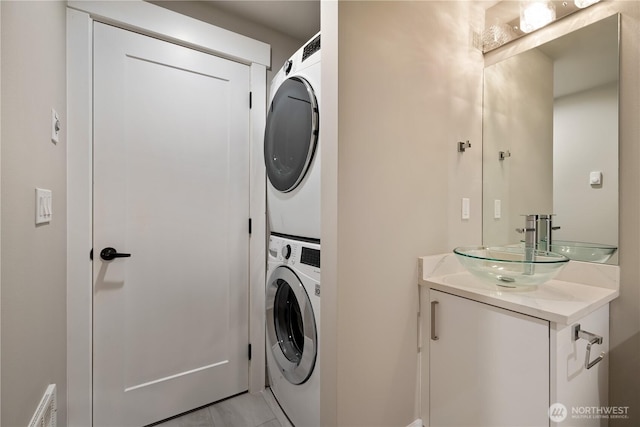 1315 Astor St, Bellingham, WA 98225 - laundry room with stacked washer and clothes dryer and light tile patterned floors