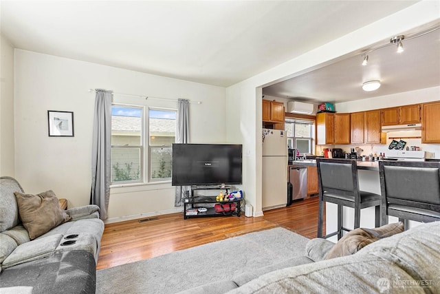 2639 Yew St, Bellingham, WA 98226 - living area featuring wood finished floors and a wall mounted air conditioner