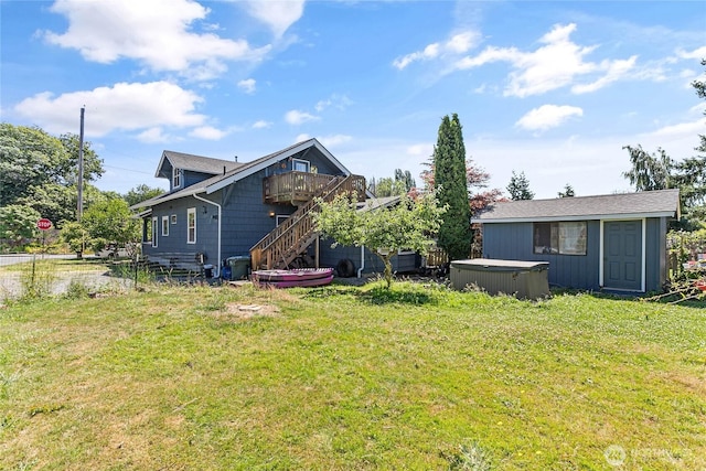 2639 Yew St, Bellingham, WA 98226 - rear view of property featuring a hot tub, a yard, an outbuilding, stairs, and a deck