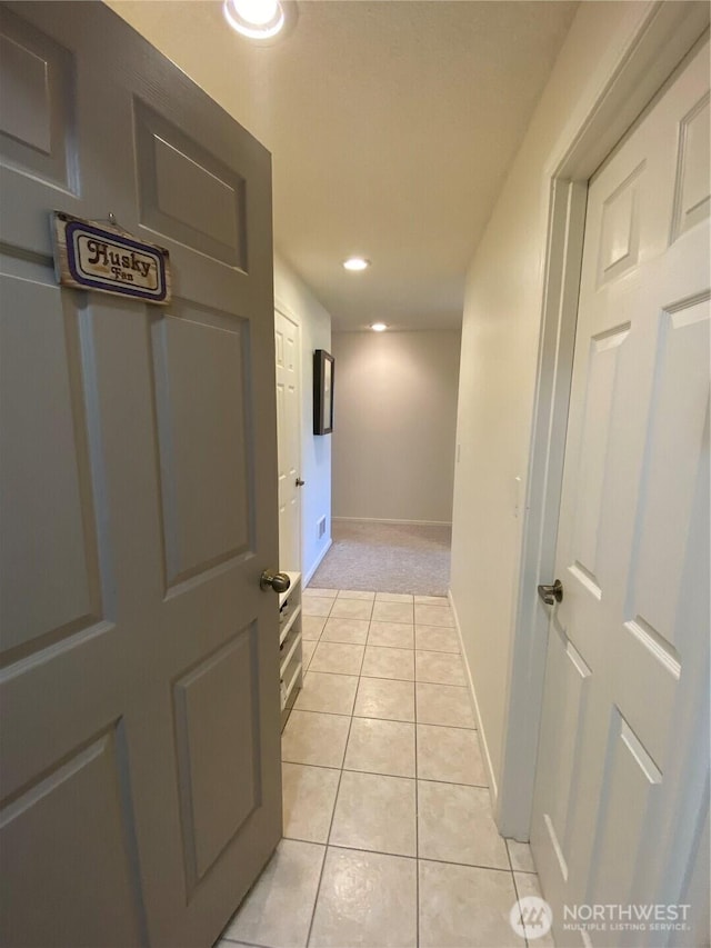 1051 Ocean Shores Blvd SW Unit 1B, Ocean Shores, WA 98569 - hallway with light tile patterned floors, recessed lighting, and light colored carpet
