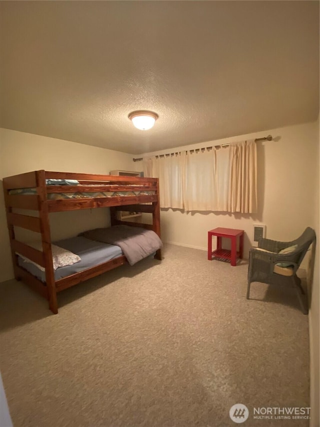 1051 Ocean Shores Blvd SW Unit 1B, Ocean Shores, WA 98569 - bedroom featuring a textured ceiling and carpet flooring