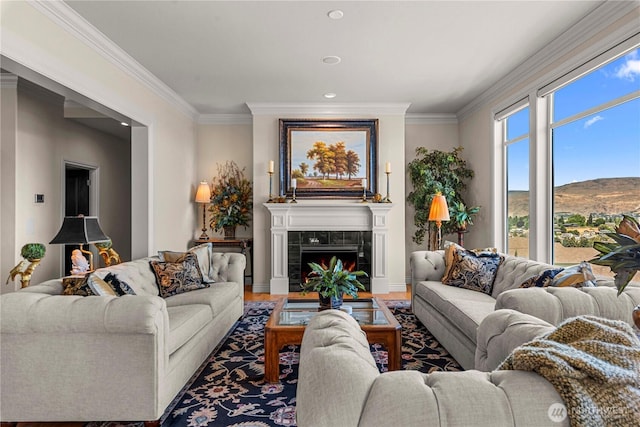1776 Broadway Pl, Wenatchee, WA 98801 - living room featuring wood finished floors, ornamental molding, a mountain view, recessed lighting, and a tiled fireplace