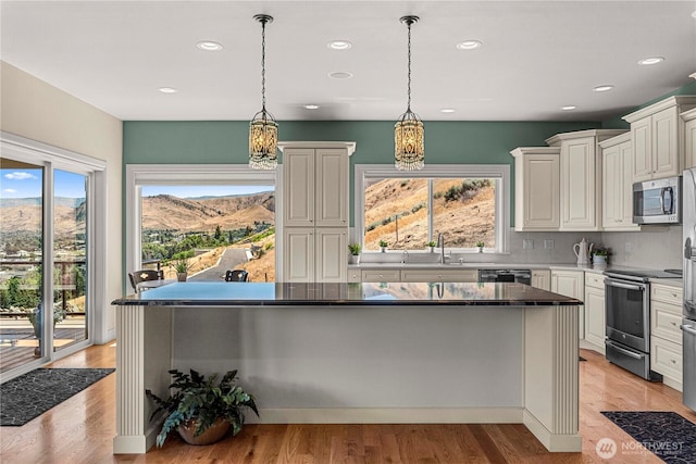 1776 Broadway Pl, Wenatchee, WA 98801 - kitchen with appliances with stainless steel finishes, recessed lighting, decorative light fixtures, light wood-type flooring, and decorative backsplash
