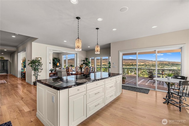 1776 Broadway Pl, Wenatchee, WA 98801 - kitchen featuring light wood-style floors, white cabinets, recessed lighting, pendant lighting, and a center island