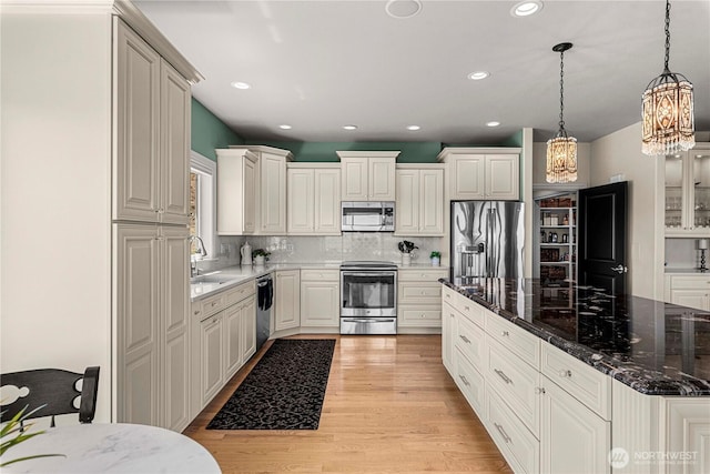 1776 Broadway Pl, Wenatchee, WA 98801 - kitchen with stainless steel appliances, a chandelier, decorative backsplash, recessed lighting, and pendant lighting