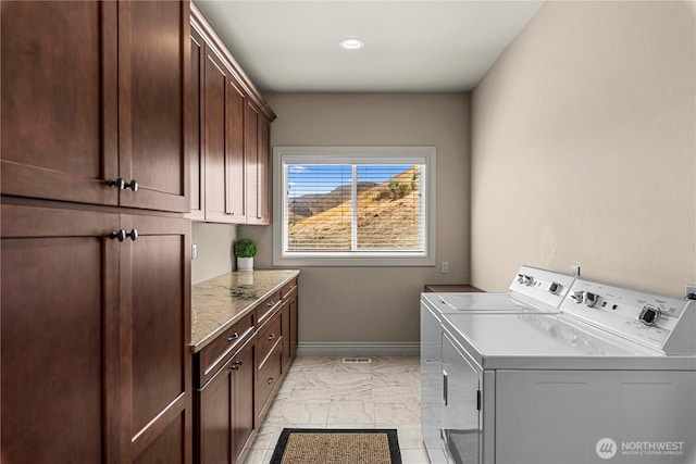 1776 Broadway Pl, Wenatchee, WA 98801 - laundry area featuring independent washer and dryer, cabinet space, and light marble finish floors