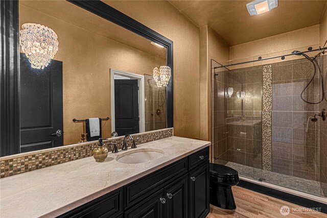 1776 Broadway Pl, Wenatchee, WA 98801 - bathroom with a stall shower, vanity, wood finished floors, a chandelier, and a textured wall
