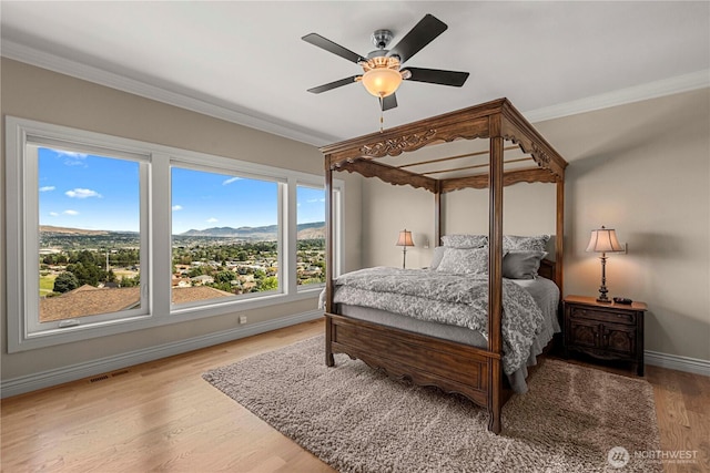 1776 Broadway Pl, Wenatchee, WA 98801 - bedroom with crown molding, wood finished floors, ceiling fan, and a mountain view