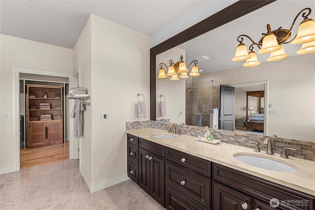 1776 Broadway Pl, Wenatchee, WA 98801 - ensuite bathroom with a chandelier, double vanity, tiled shower, decorative backsplash, and a walk in closet