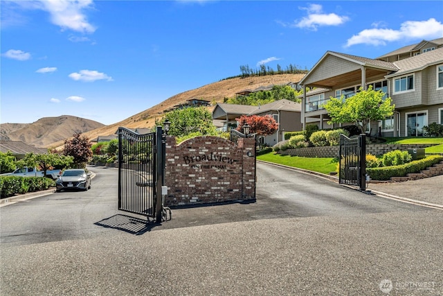 1776 Broadway Pl, Wenatchee, WA 98801 - view of asphalt road with a mountain view, curbs, a gate, a gated entry, and a residential view