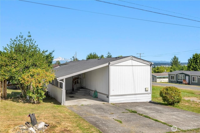 5594 Hillvue Rd, Blaine, WA 98230 - view of front of home with a carport, driveway, a front yard, and a mountain view