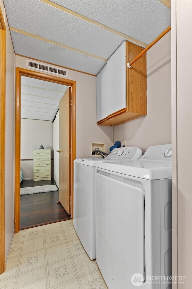 5594 Hillvue Rd, Blaine, WA 98230 - laundry area with cabinet space, separate washer and dryer, tile patterned floors, and a textured ceiling