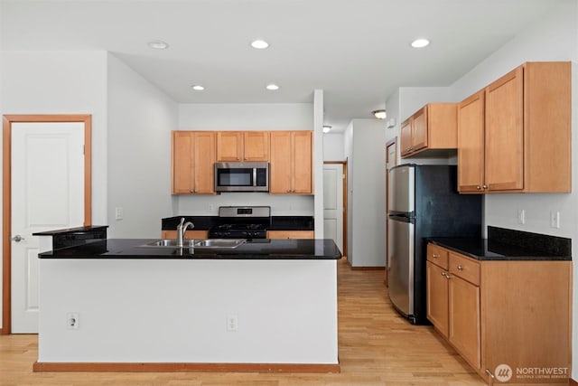 6214 Malloy Ave, Ferndale, WA 98248 - kitchen with stainless steel appliances, light wood-style floors, dark countertops, and recessed lighting