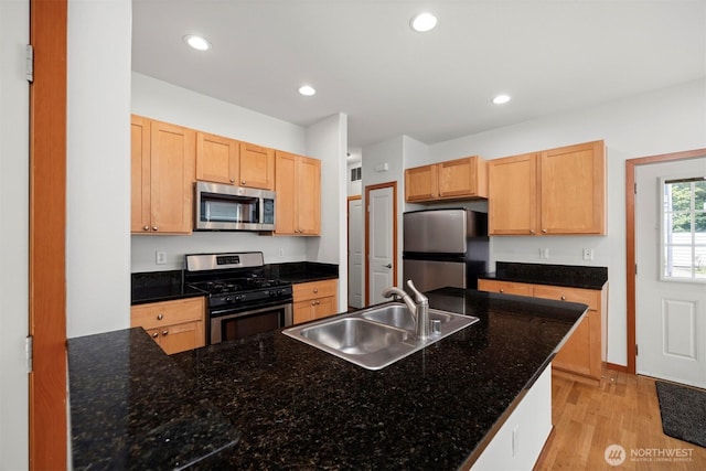 6214 Malloy Ave, Ferndale, WA 98248 - kitchen with stainless steel appliances, light wood-type flooring, recessed lighting, light brown cabinetry, and a peninsula