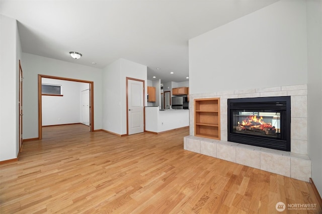 6214 Malloy Ave, Ferndale, WA 98248 - unfurnished living room featuring light wood-style floors, a fireplace, and recessed lighting