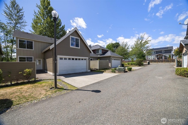 6214 Malloy Ave, Ferndale, WA 98248 - craftsman-style home featuring asphalt driveway, an attached garage, and board and batten siding