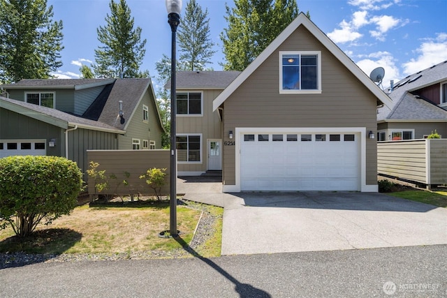 6214 Malloy Ave, Ferndale, WA 98248 - view of front of home with a garage, driveway, board and batten siding, and a shingled roof