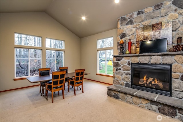 6214 Malloy Ave, Ferndale, WA 98248 - dining space with carpet floors, a stone fireplace, and high vaulted ceiling