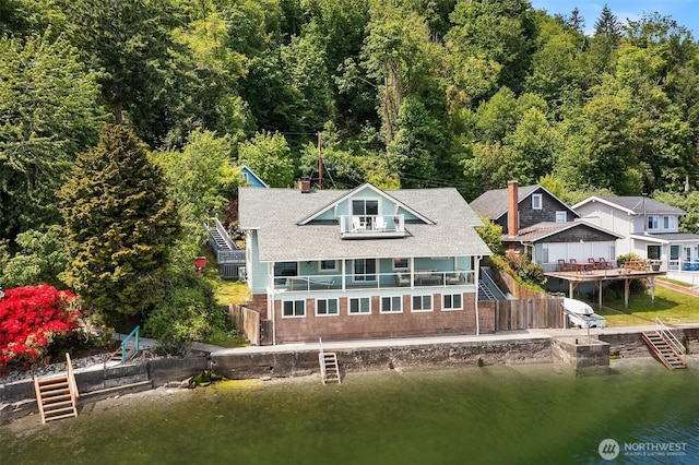 26321 Pillsbury Rd SW, Vashon, WA 98070 - rear view of house featuring stairway, a chimney, a forest view, and a balcony