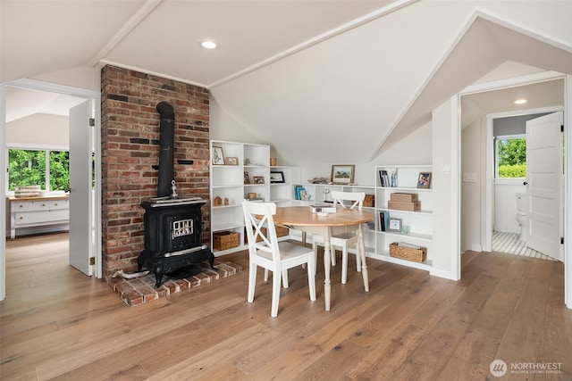 26321 Pillsbury Rd SW, Vashon, WA 98070 - dining space with vaulted ceiling, a wood stove, hardwood / wood-style floors, plenty of natural light, and recessed lighting