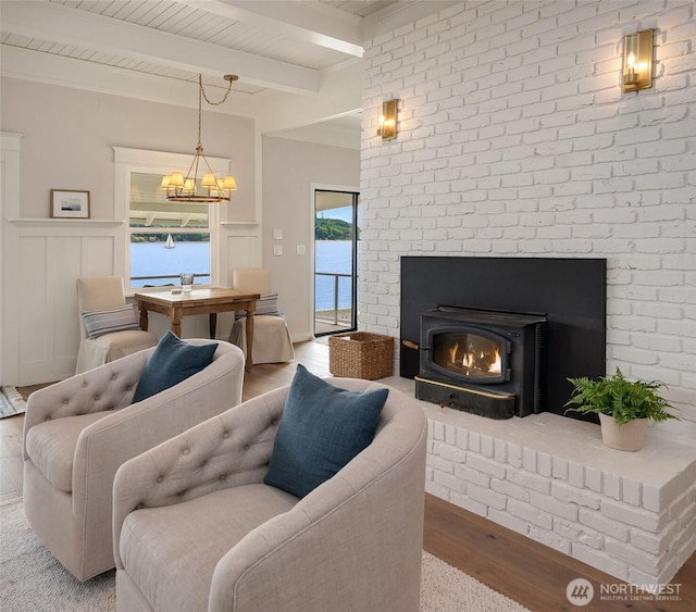 26321 Pillsbury Rd SW, Vashon, WA 98070 - living area with beamed ceiling, a chandelier, wood finished floors, and a wainscoted wall