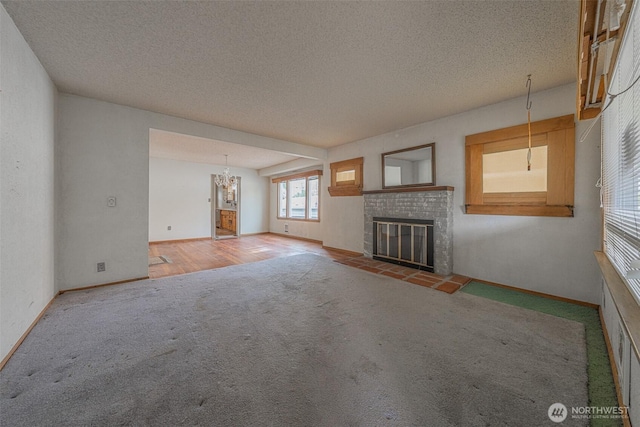 5507 N 45th St, Tacoma, WA 98407 - unfurnished living room with carpet flooring, a brick fireplace, and a textured ceiling