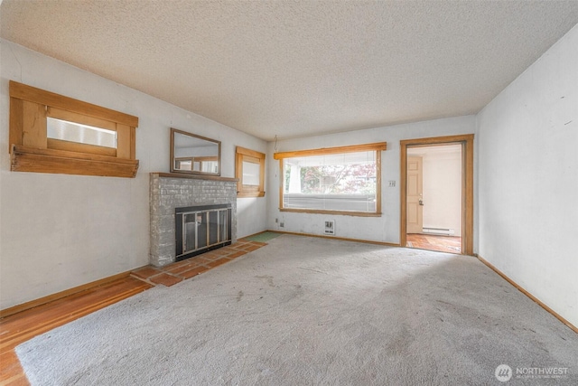 5507 N 45th St, Tacoma, WA 98407 - unfurnished living room featuring a textured ceiling, a fireplace, carpet floors, and a baseboard radiator