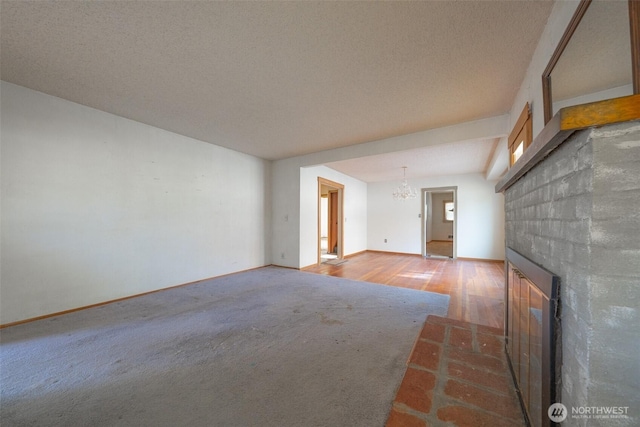 5507 N 45th St, Tacoma, WA 98407 - unfurnished living room featuring carpet flooring, a fireplace, a chandelier, and wood finished floors