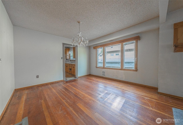 5507 N 45th St, Tacoma, WA 98407 - unfurnished dining area with a chandelier, hardwood / wood-style flooring, and a textured ceiling