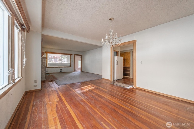 5507 N 45th St, Tacoma, WA 98407 - unfurnished dining area featuring wood-type flooring, a chandelier, and a textured ceiling