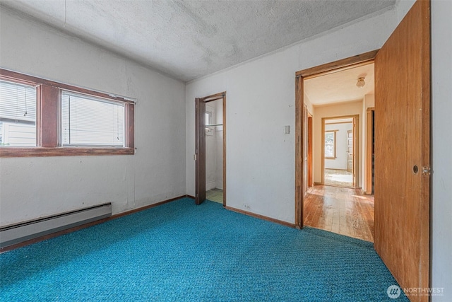 5507 N 45th St, Tacoma, WA 98407 - unfurnished bedroom featuring carpet floors, a textured ceiling, baseboard heating, and a closet
