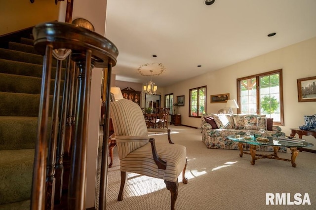 living room featuring light carpet and an inviting chandelier