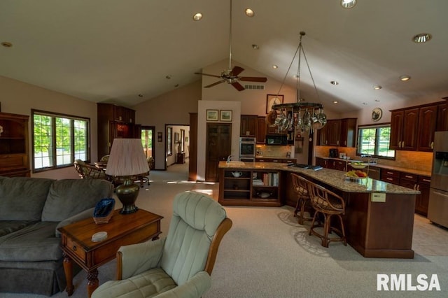 interior space featuring ceiling fan, sink, light carpet, and high vaulted ceiling