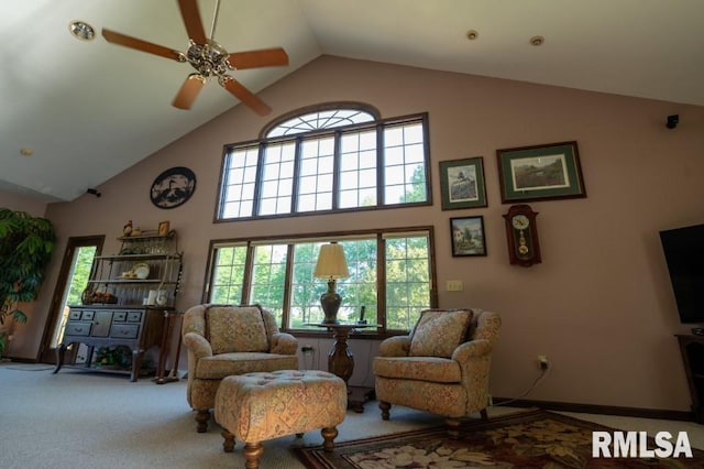 carpeted living room featuring high vaulted ceiling and ceiling fan