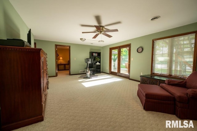 carpeted living room featuring ceiling fan