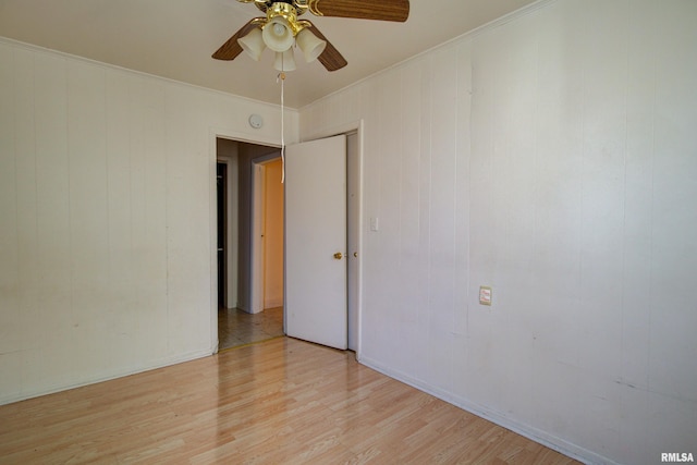 spare room with ceiling fan and light wood-type flooring