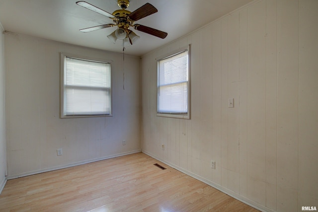 unfurnished room with ceiling fan and light wood-type flooring